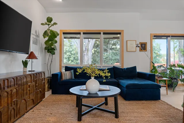 a living room with furniture and large windows