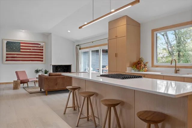 a view of living room with granite countertop furniture a flat screen tv and a refrigerator