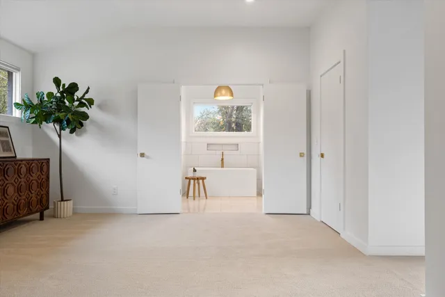 a bed sitting in a bedroom next to a window