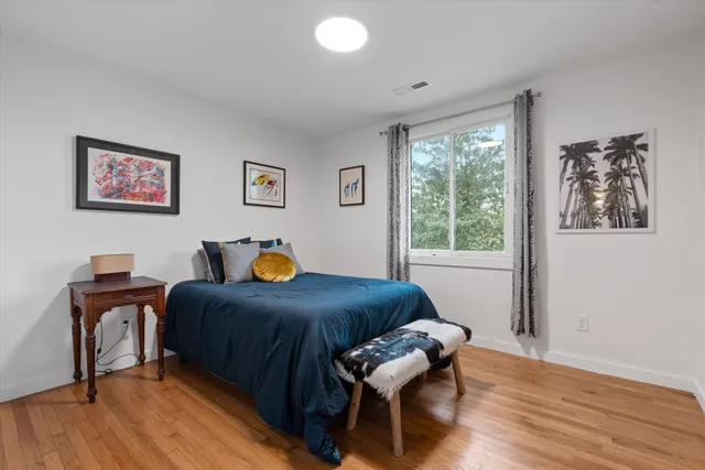 a reading room with furniture and a potted plant