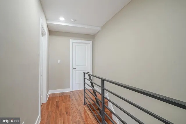 a view of hallway with wooden floor