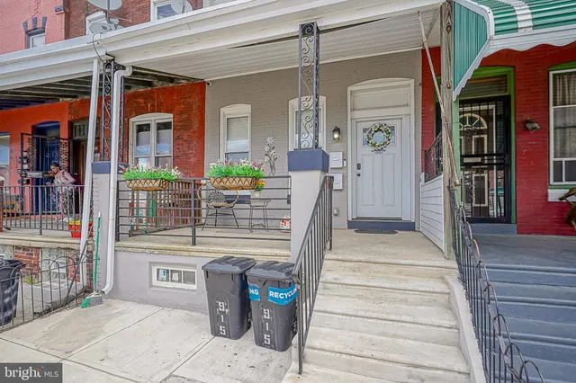 a front view of a building with outdoor seating