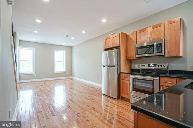 a kitchen with stainless steel appliances a refrigerator microwave and stove