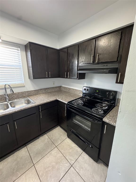1195 Bentley Road, Unit 1 Leesburg, FL 34748 - Photo 6 of 13 a kitchen with a sink stove and cabinets