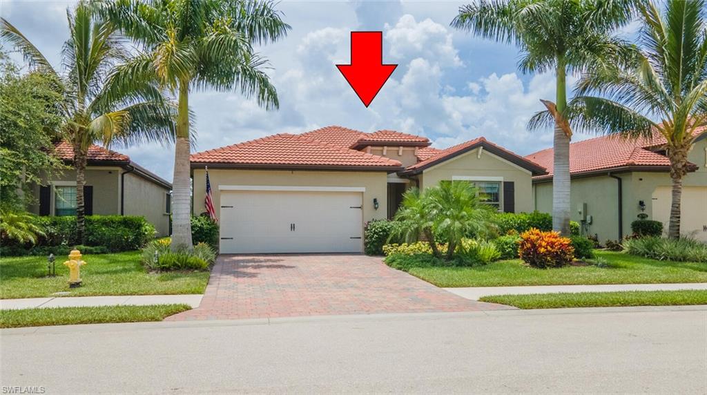 16366 Barclay Court Naples, FL 34110 - Photo 33 of 35 a front view of a house with a garden and trees