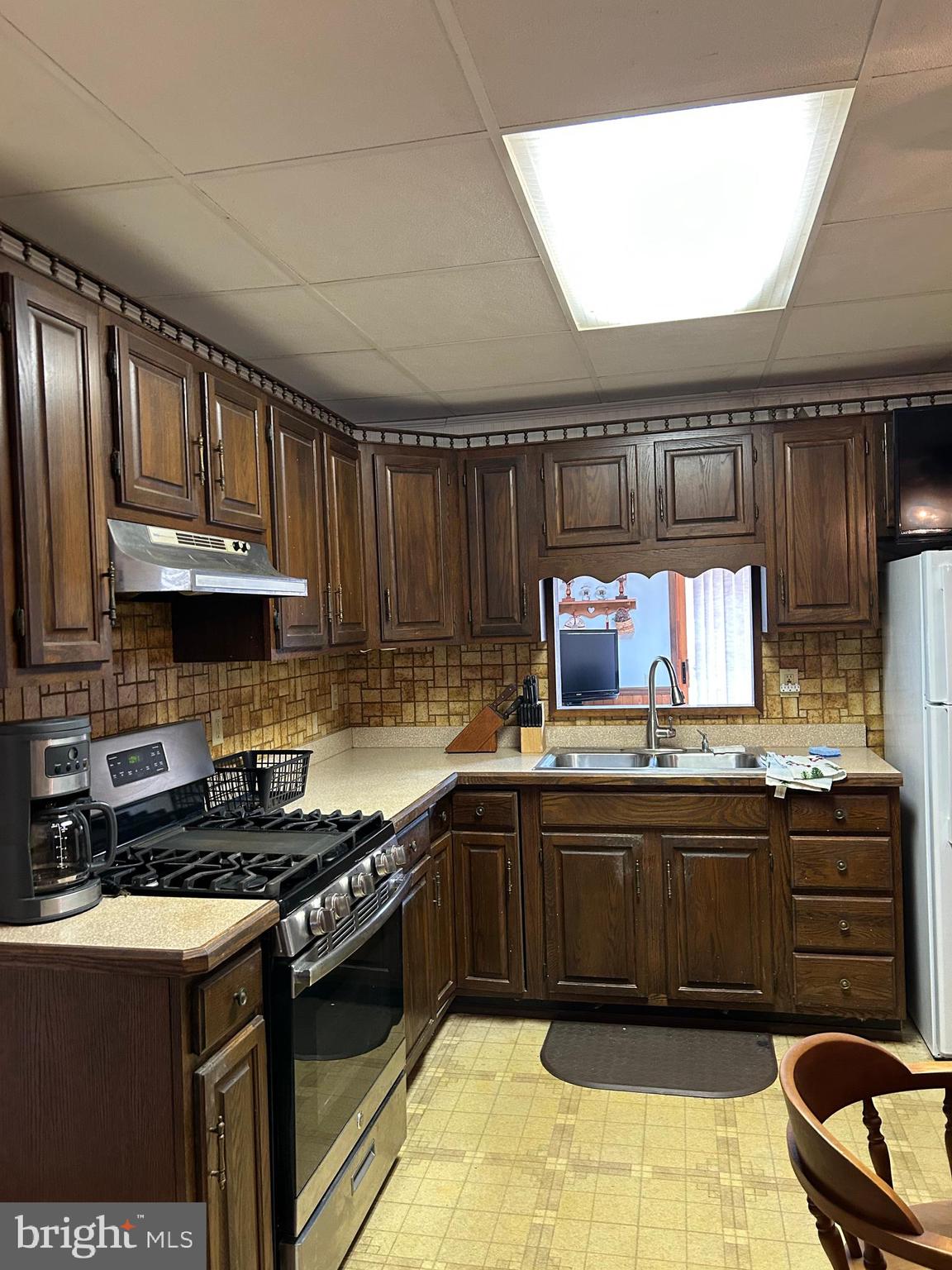 124 Karl Drive Dover, DE 19901 - Photo 38 of 58 a kitchen with granite countertop a sink a stove and cabinets