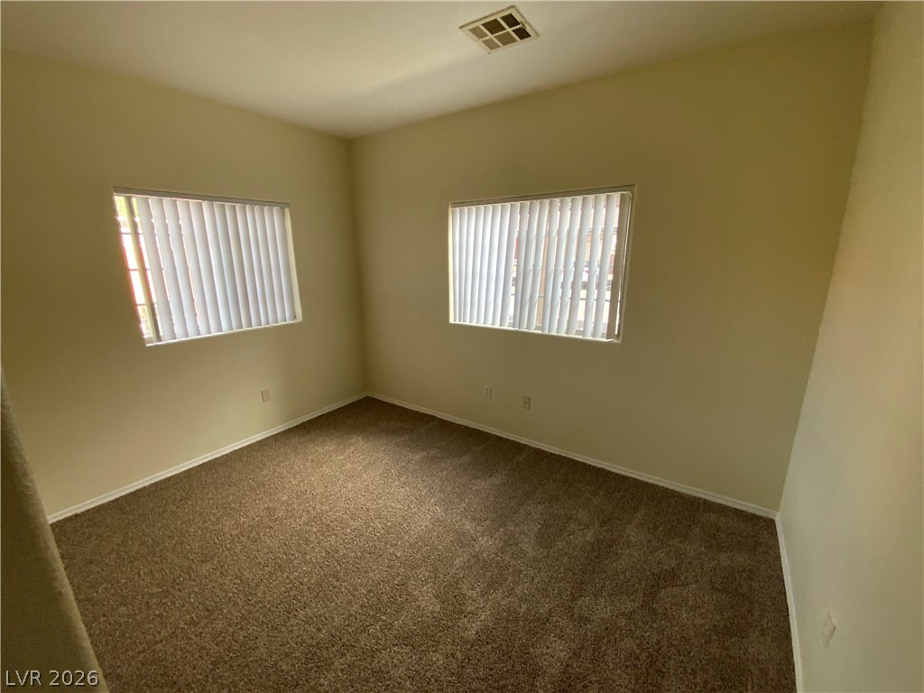 4730 East Craig Road, Unit 1091 Las Vegas, NV 89115 - Photo 10 of 14 Sun-filled room featuring plush carpeting and large windows with blinds.