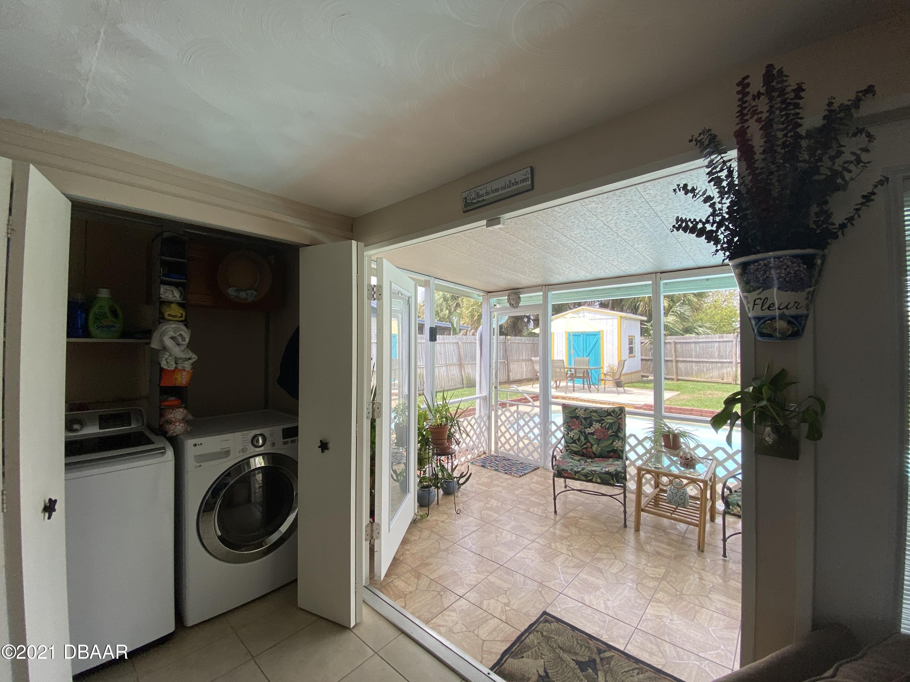 53 Seacrest Drive Ormond Beach, FL 32176 - Photo 12 of 34 a dining room with furniture and a floor to ceiling window