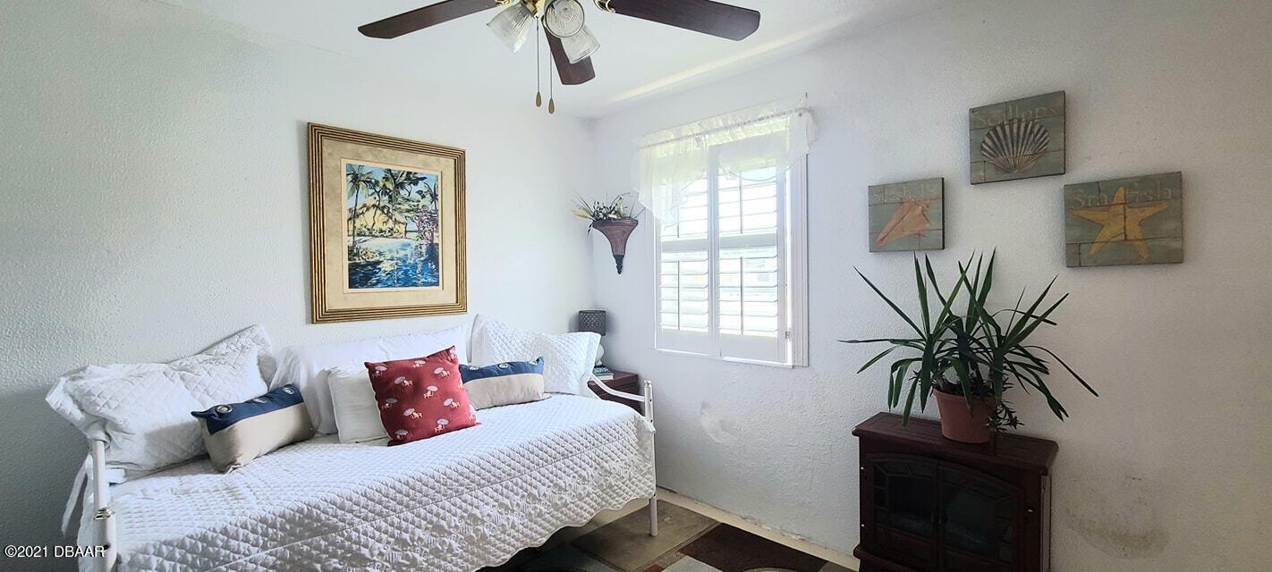 53 Seacrest Drive Ormond Beach, FL 32176 - Photo 18 of 34 a bedroom with furniture and a window