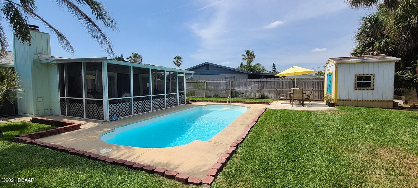 53 Seacrest Drive Ormond Beach, FL 32176 - Photo 28 of 34 a view of a house with pool and a yard