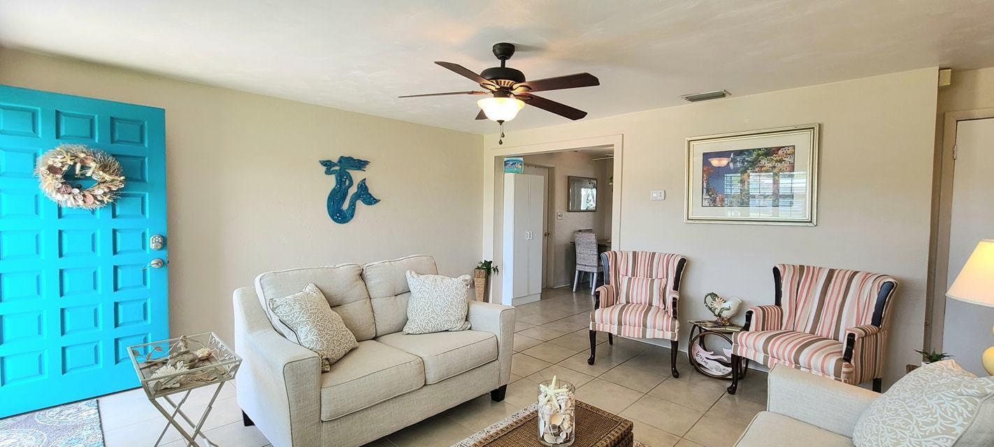 53 Seacrest Drive Ormond Beach, FL 32176 - Photo 4 of 34 a living room with furniture a ceiling fan and a window