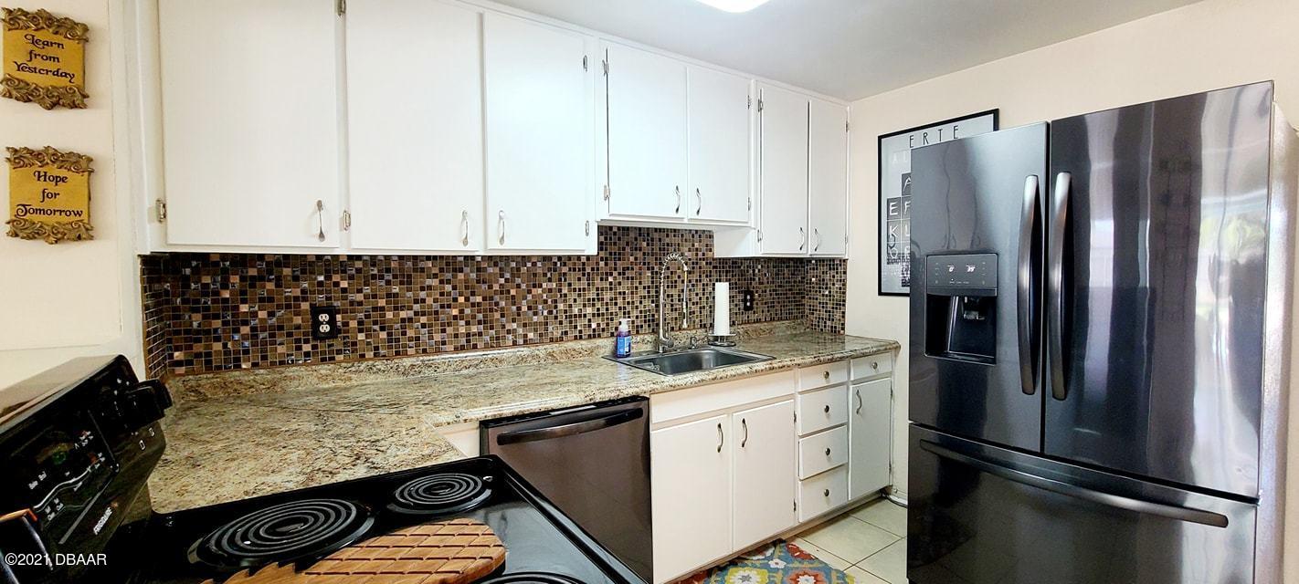 53 Seacrest Drive Ormond Beach, FL 32176 - Photo 8 of 34 a kitchen with a refrigerator and a sink