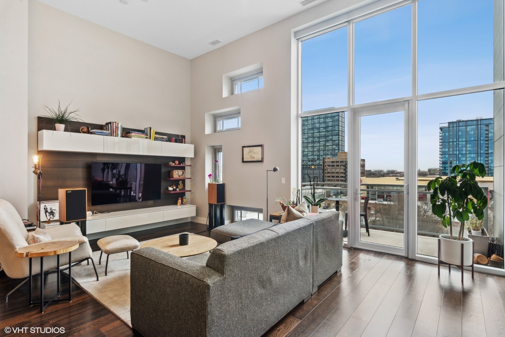 1116 West Adams Street, Unit PHW Chicago, IL 60607 - Photo 4 of 18 a living room with furniture a large window and a fireplace