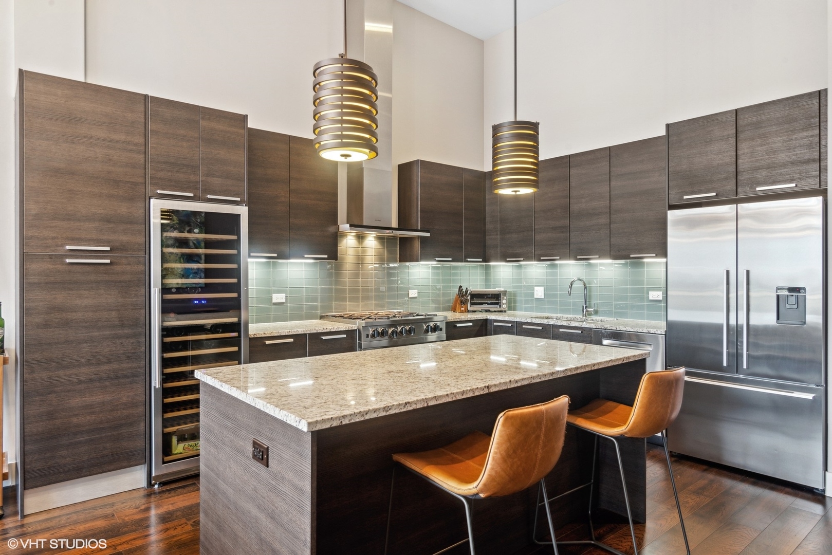 1116 West Adams Street, Unit PHW Chicago, IL 60607 - Photo 5 of 18 a kitchen counter space a sink and chairs