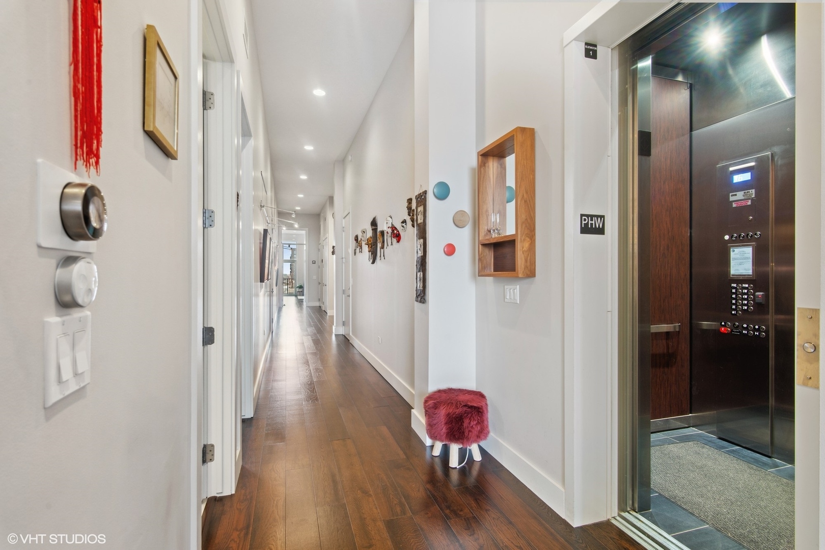 1116 West Adams Street, Unit PHW Chicago, IL 60607 - Photo 7 of 18 a view of a hallway with wooden floor and living room