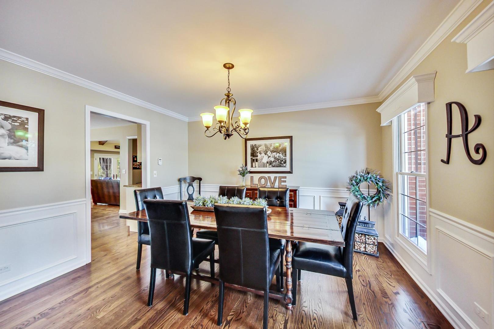 2616 High Meadow Road Naperville, IL 60564 - Photo 12 of 47 a view of a dining room with furniture a chandelier and wooden floor