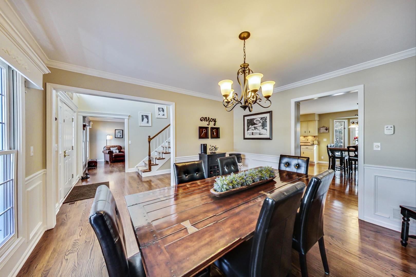 2616 High Meadow Road Naperville, IL 60564 - Photo 13 of 47 a view of a dining room with furniture wooden floor and chandelier