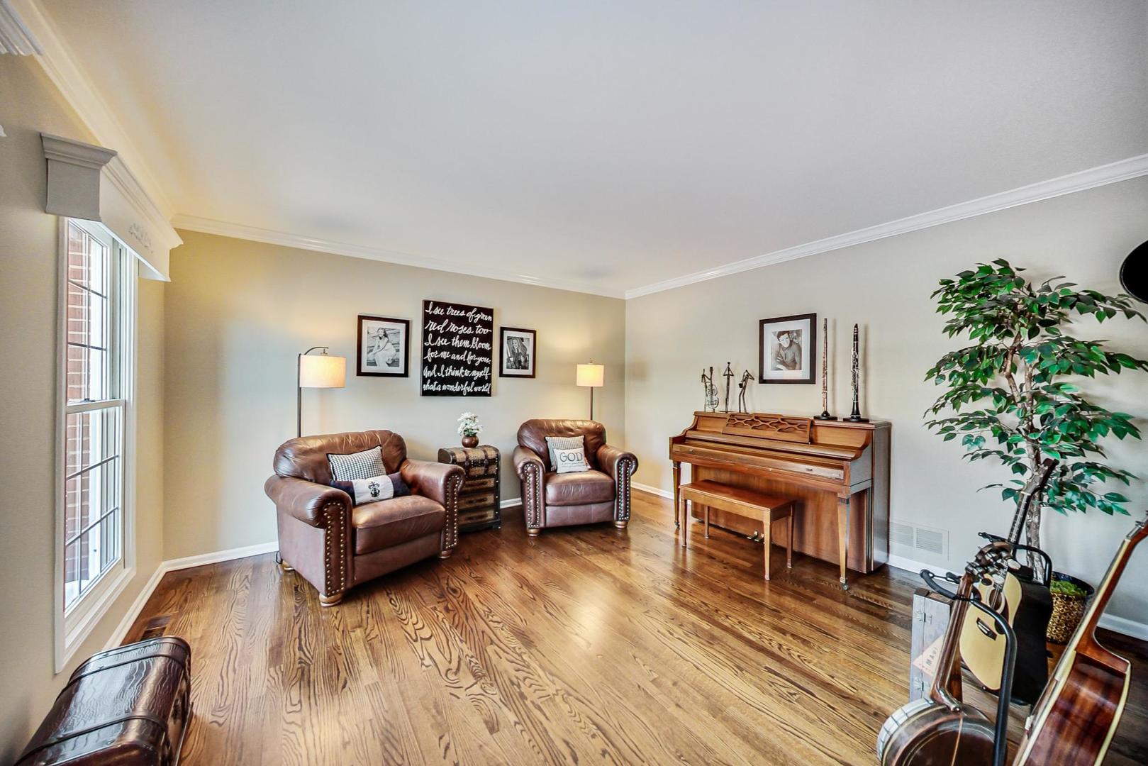 2616 High Meadow Road Naperville, IL 60564 - Photo 14 of 47 a living room with furniture a piano and a potted plant
