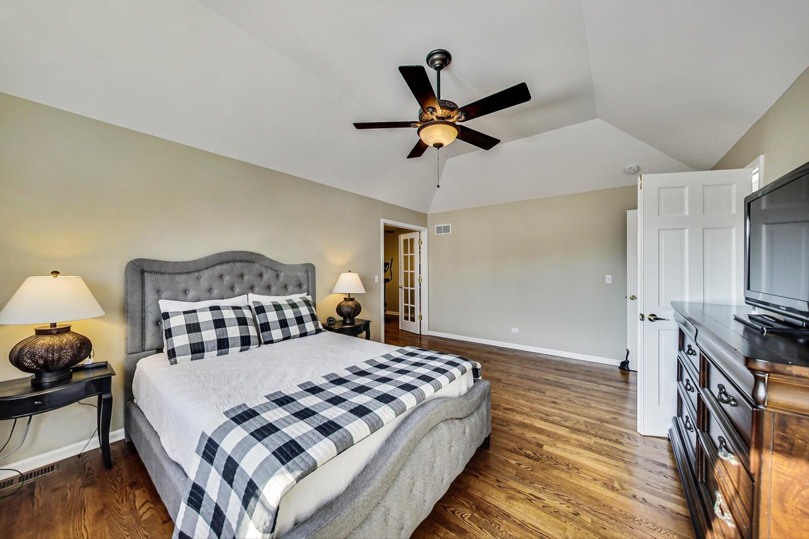 2616 High Meadow Road Naperville, IL 60564 - Photo 19 of 47 a bedroom with a bed and wooden floor