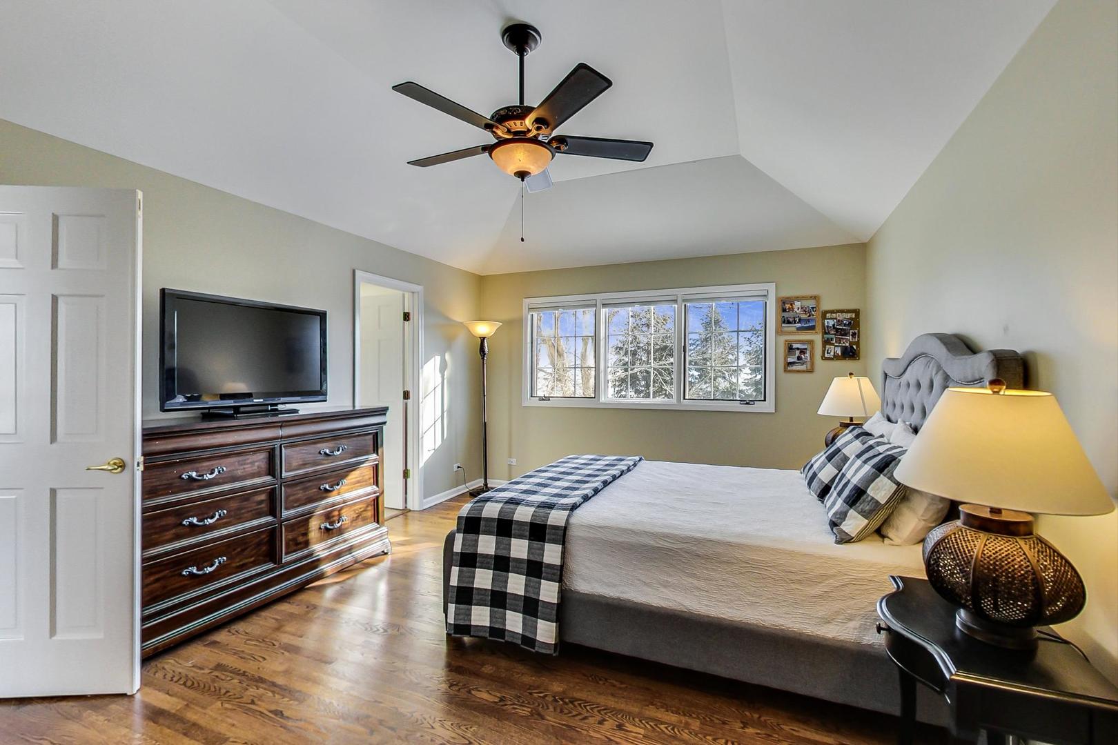2616 High Meadow Road Naperville, IL 60564 - Photo 20 of 47 a bedroom with a bed and a flat screen tv