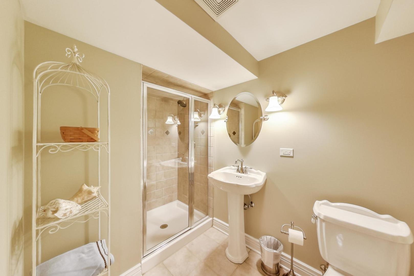 2616 High Meadow Road Naperville, IL 60564 - Photo 39 of 47 a bathroom with a toilet a sink and glass door