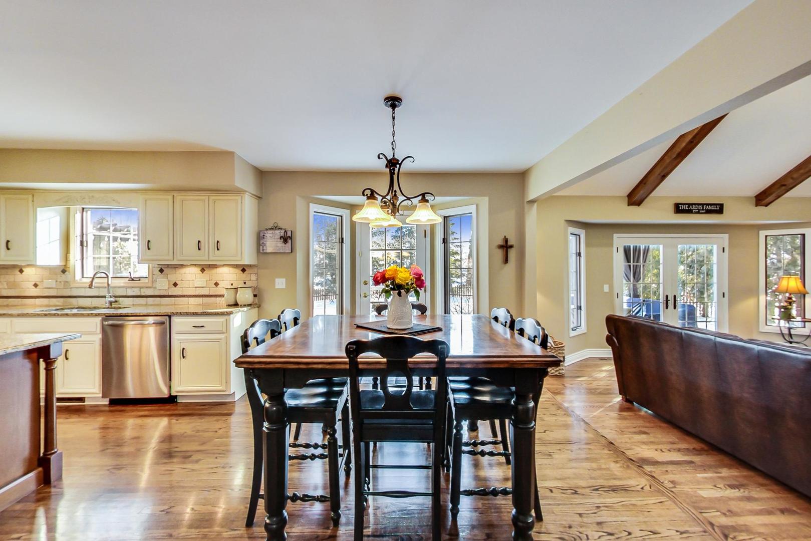 2616 High Meadow Road Naperville, IL 60564 - Photo 7 of 47 a dining room with a wooden table and chairs