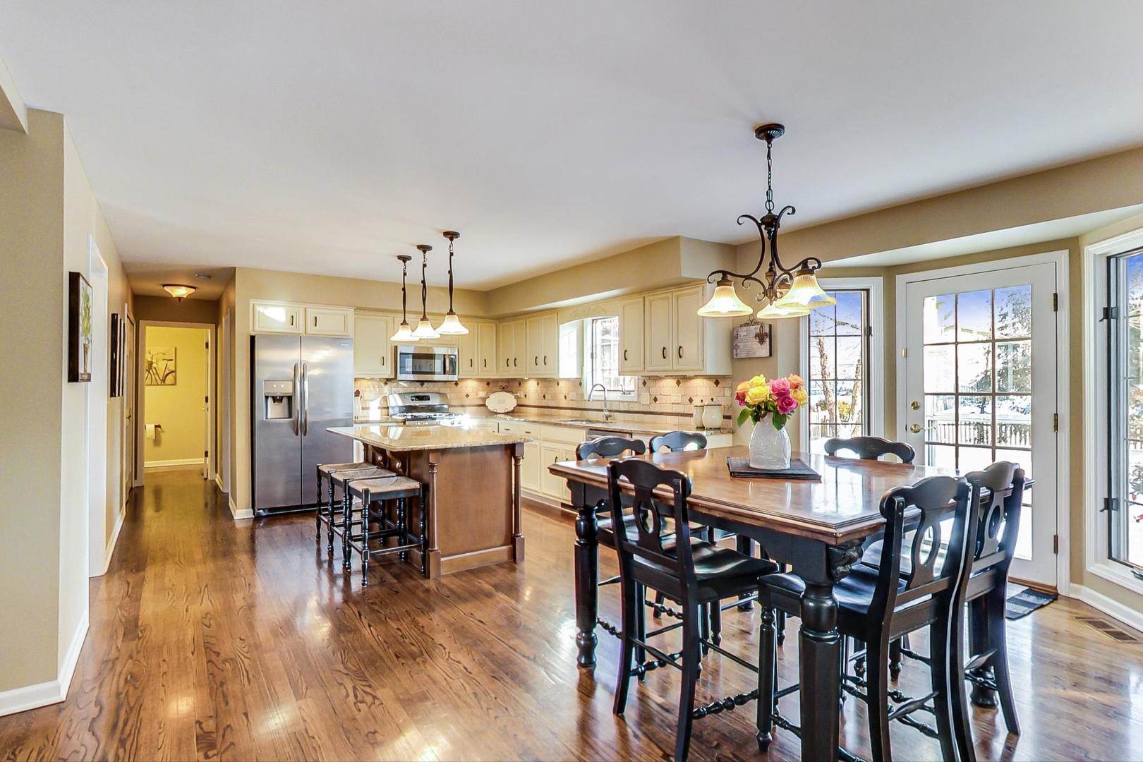 2616 High Meadow Road Naperville, IL 60564 - Photo 8 of 47 a dining room with furniture window and wooden floor