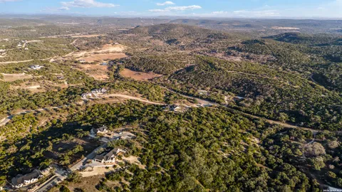 an aerial view of house with yard and mountain view in back