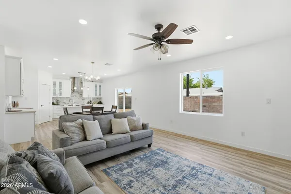 a living room with furniture and a wooden floor