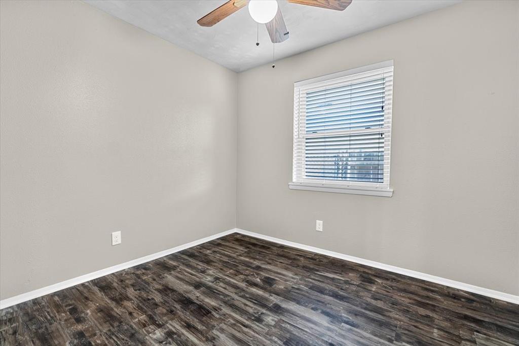 1251 Donna Drive Richardson, TX 75080 - Photo 17 of 39 a view of a room with wooden floor and windows