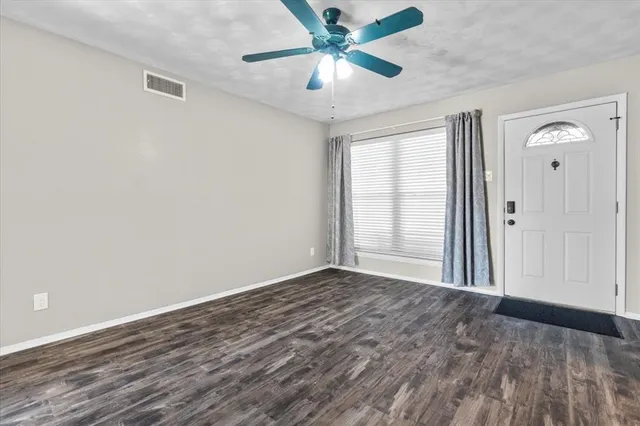 wooden floor in an empty room with a window