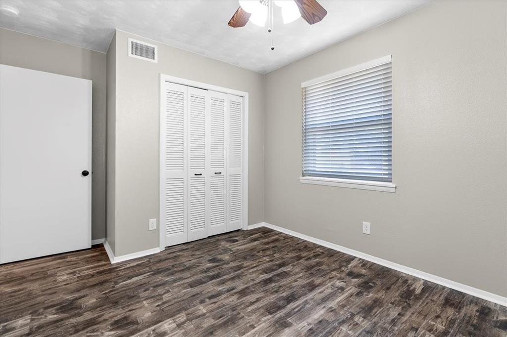 1251 Donna Drive Richardson, TX 75080 - Photo 22 of 39 a view of an empty room with wooden floor and a window