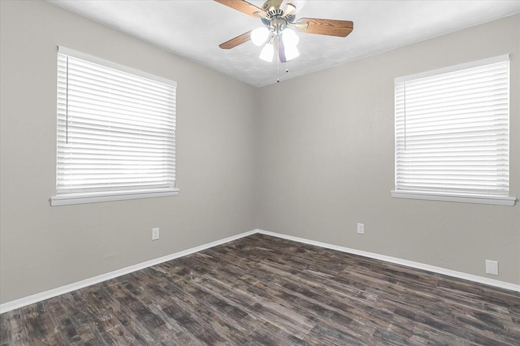 1251 Donna Drive Richardson, TX 75080 - Photo 25 of 39 a view of an empty room with wooden floor and a window