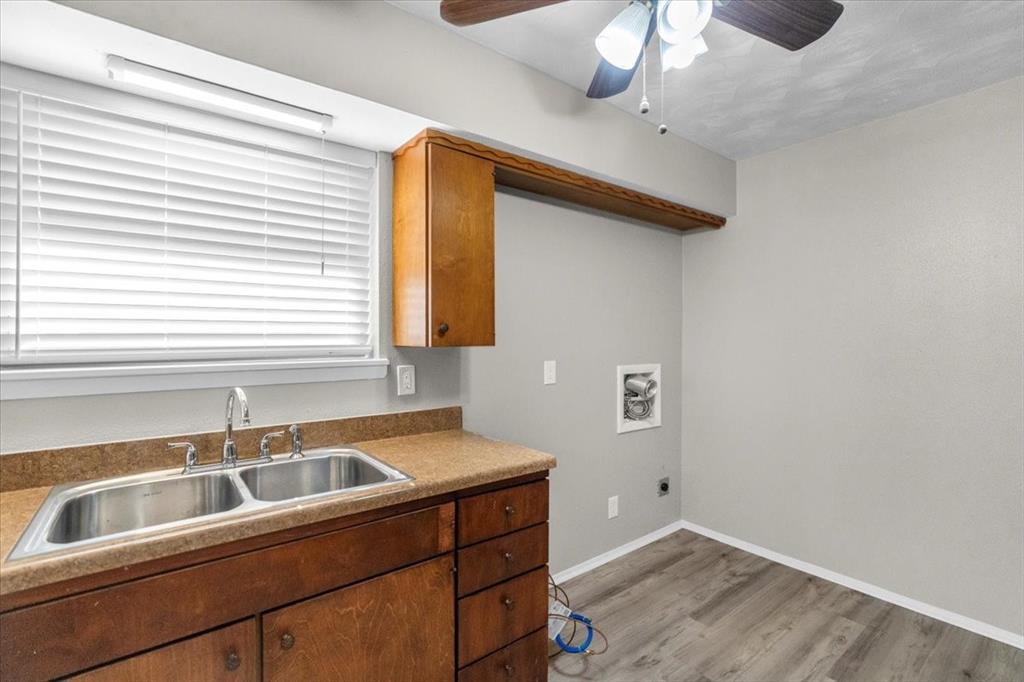 1251 Donna Drive Richardson, TX 75080 - Photo 9 of 39 a kitchen with a sink cabinets and window