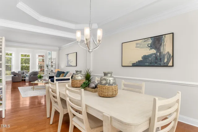 a view of a dining room with furniture wooden floor and chandelier