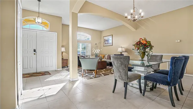 a view of a dining room with furniture and a chandelier