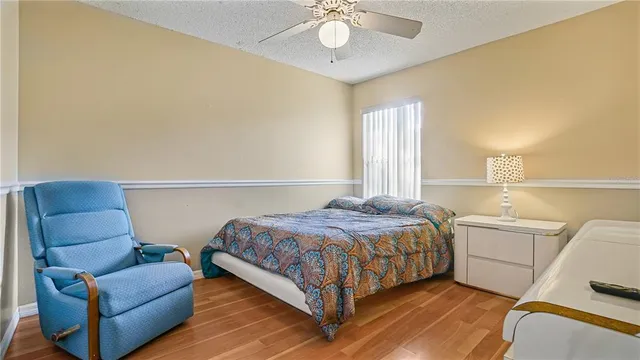 a bedroom with a bed couch and window