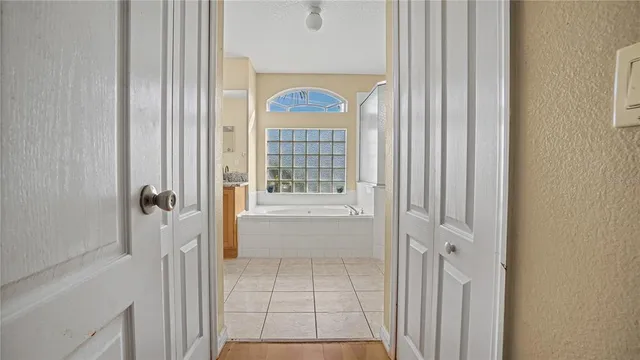 a bathroom with a glass shower door and a glass door