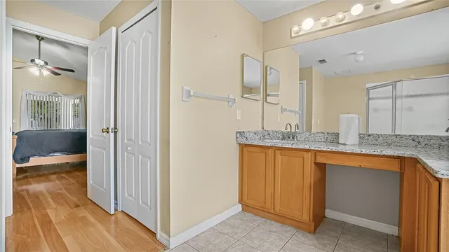 a bathroom with a granite countertop sink a toilet and shower