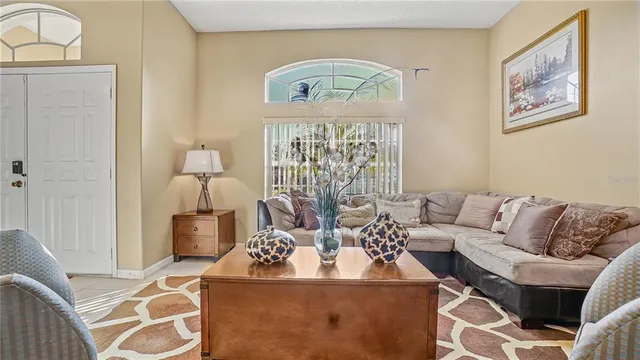 a living room with furniture and a chandelier