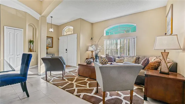 a living room with furniture a window and a lamp
