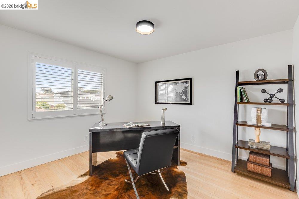 1298 Ribbon Street Foster City, CA 94404 - Photo 46 of 86 Wood-finish flooring with white baseboards, a window featuring white plantation shutters, and a ceiling-mounted light fixture