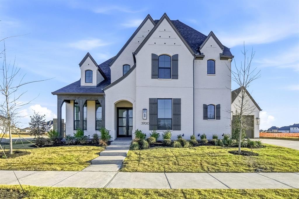 3700 Meander Way Prosper, TX 75078 - Photo 1 of 29 a view of a white house with large windows and a yard
