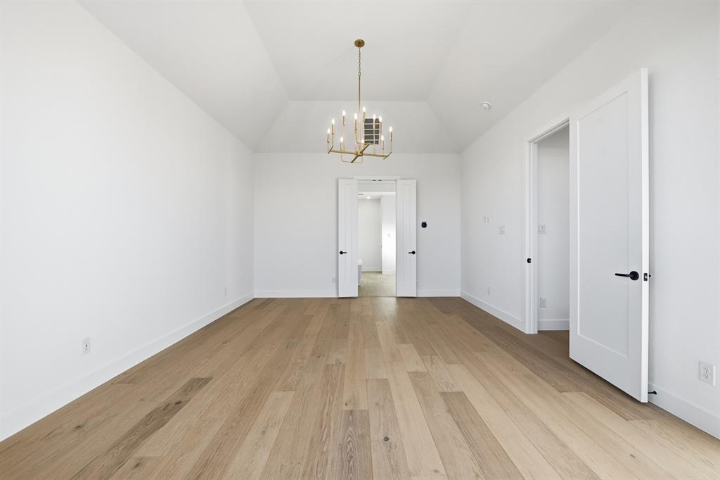 3700 Meander Way Prosper, TX 75078 - Photo 11 of 29 a view of a room with wooden floor and ceiling fan
