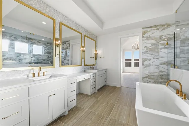 a bathroom with a double vanity sink a mirror a bathtub and shower