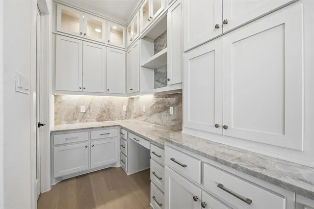 a kitchen with granite countertop white cabinets and white appliances