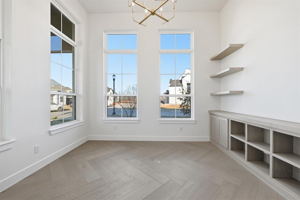 3700 Meander Way Prosper, TX 75078 - Photo 16 of 29 an empty room with windows on wall and white walls