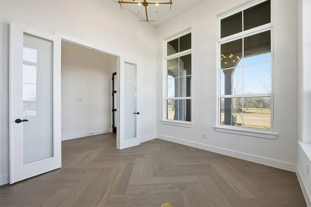 an empty room with windows and closet