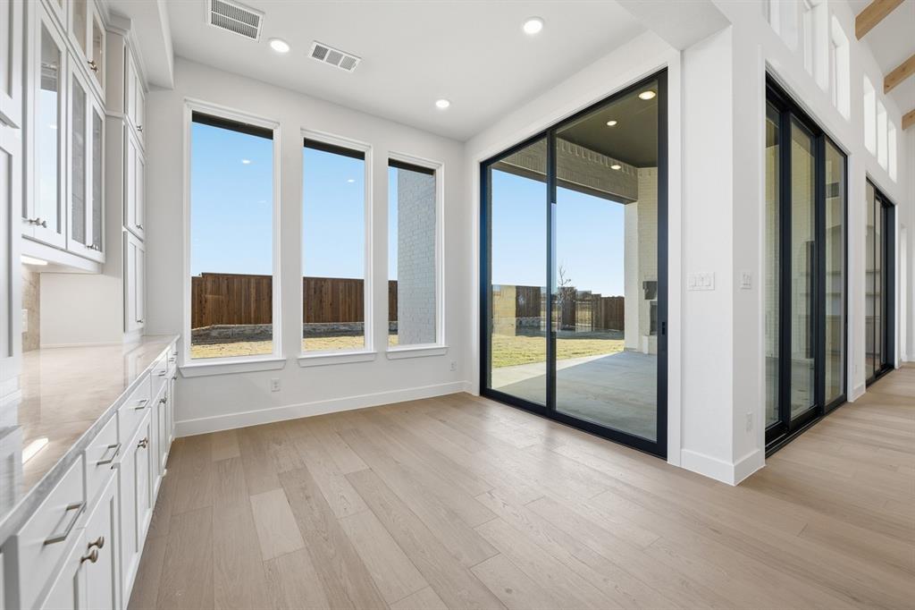 3700 Meander Way Prosper, TX 75078 - Photo 19 of 29 a view of an entryway with wooden floor and door