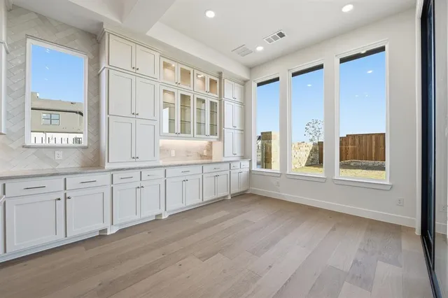 a view of a hallway with wooden floor and entryway